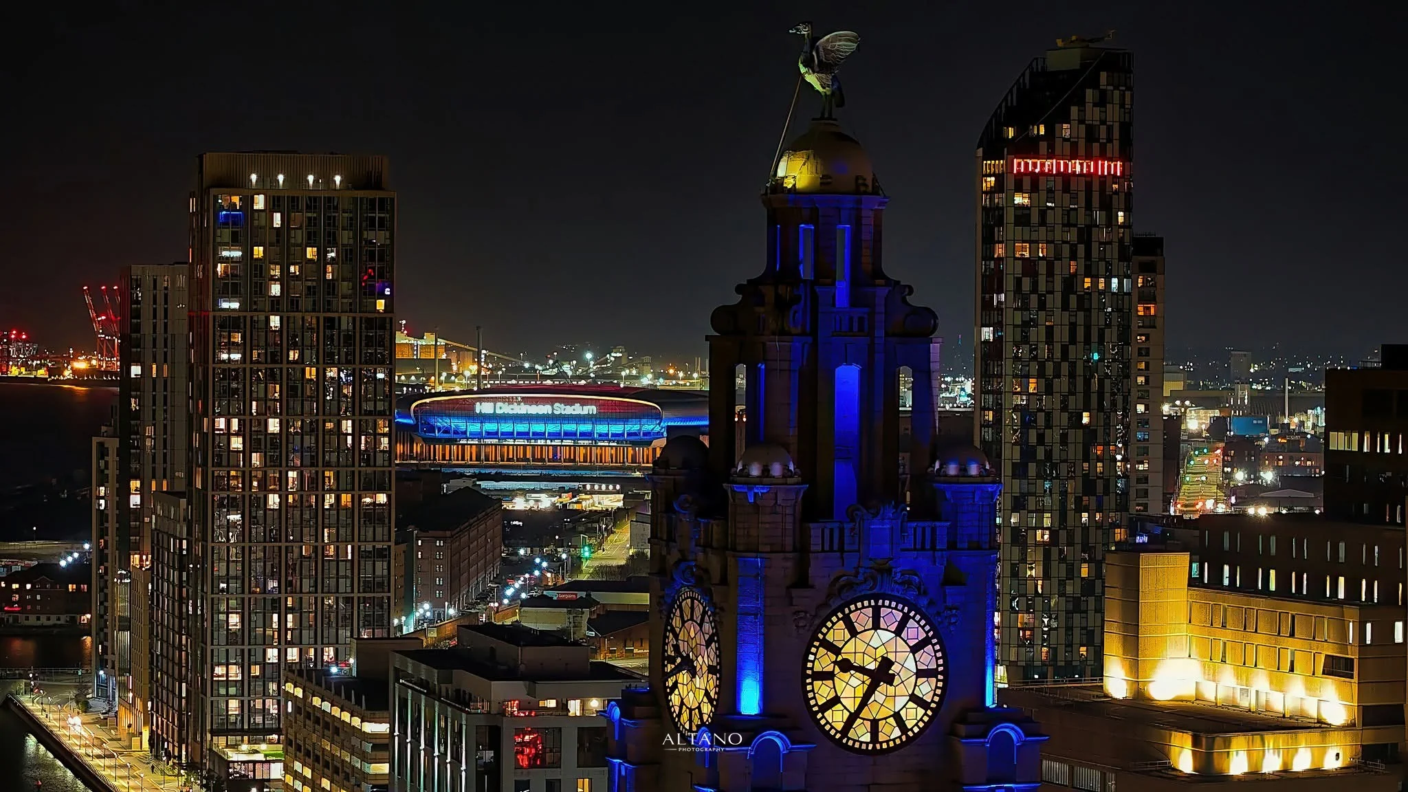 Hill Dickinson Stadium with Liverpool city centre behind at blue hour