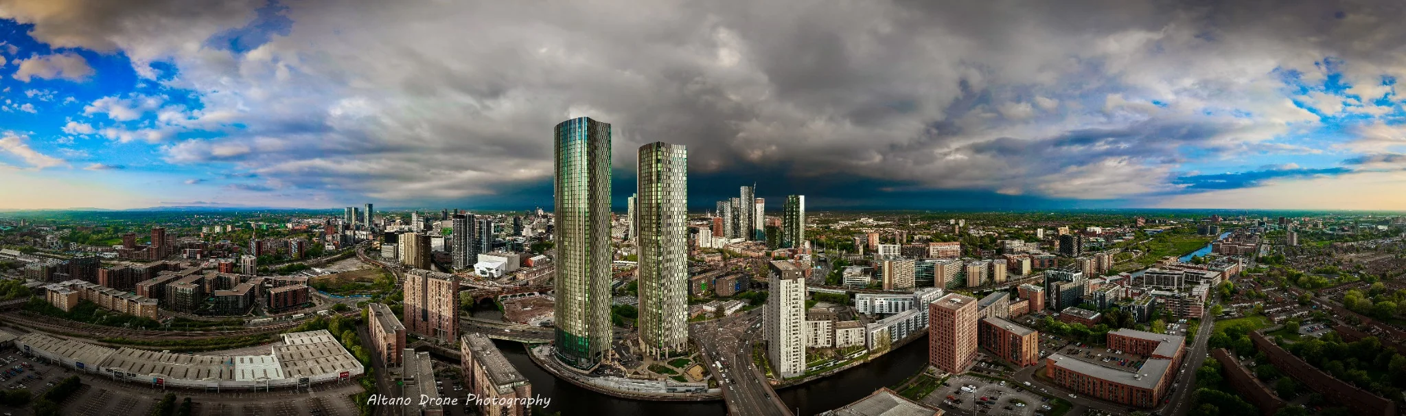 Manchester under storm clouds, Panoramic aerial cityscape
